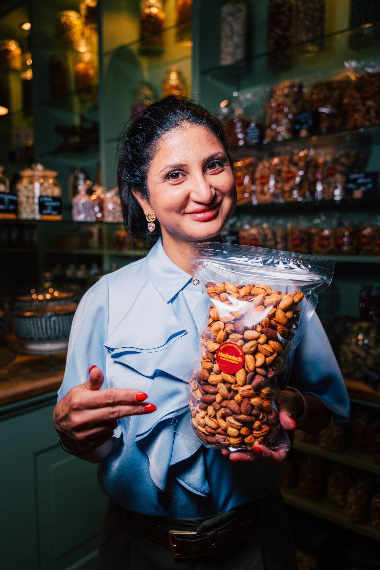 A woman holding a bag of nuts in a store